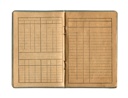front view closeup detail of small old open notebook with vintage yellow brown paper cloth cover and empty spreadsheet accounting charts inside isolated on white backgroundの写真素材