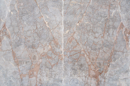 A closeup view of gray marble featuring natural brown veins in an organic patternの写真素材