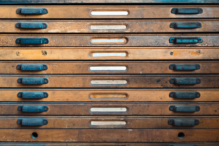 Detailed shot of vintage letterpress type storage drawers in a print shop environmentの写真素材