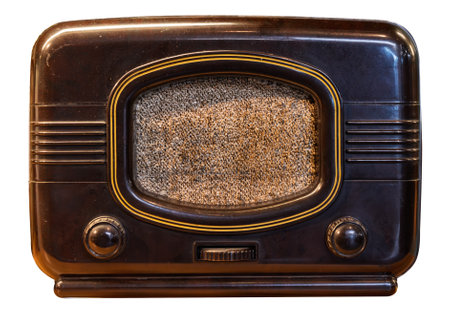 A classic black radio with a retro design featuring dials and a textured speaker panel isolated on a white backgroundの写真素材