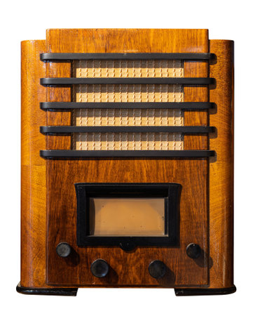 A vintage wooden radio with black accents and a front facing speaker showcasing a retro design isolated on whiteの写真素材