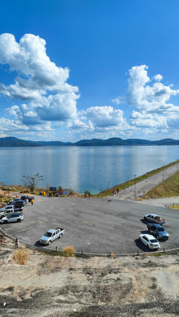 Magnificent View from the Reservoir Dam and Verdant Mountains on a Clear Dayの写真素材