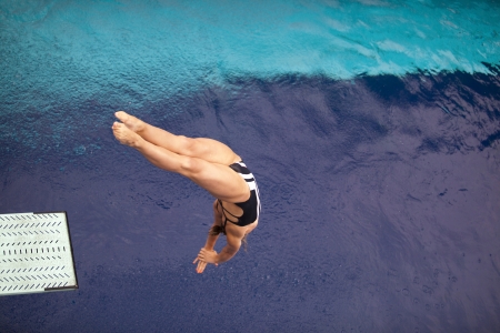 girl diving into the pool の写真素材