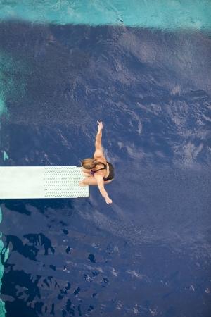 preparing to dive into a swimming pool の写真素材