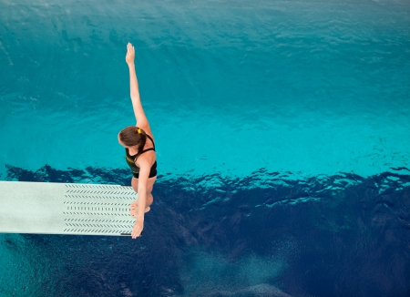 preparing to dive into a swimming pool の写真素材