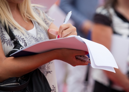 female journalist taking notesの写真素材