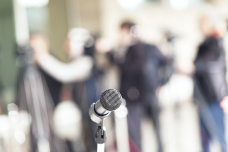 microphone in focus against blurred audience