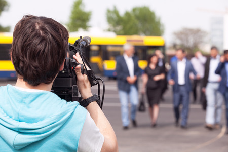 Cameraman filming unrecognizable group of peopleの写真素材