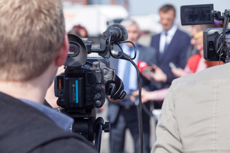 Press conference. Reporters at work, interviewing a businessman or a politician.の写真素材