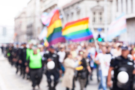 Blurred picture of LGBT pride participants escorted by policeの写真素材