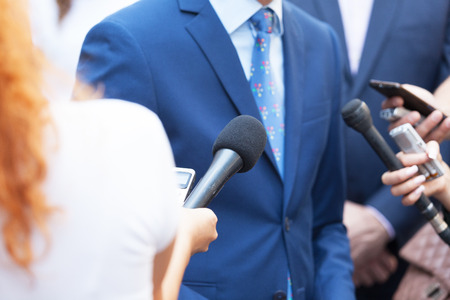 Journalists making media interview with business person or politicianの写真素材