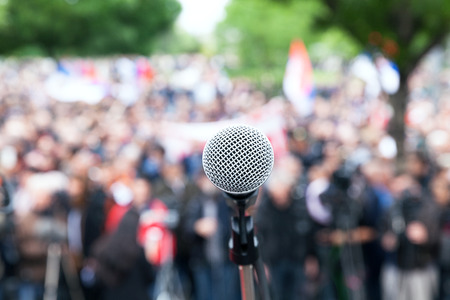 Microphone in focus against blurred protest or public demonstrationの写真素材