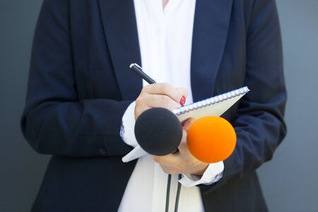 Female reporter or TV journalist at press event. Journalism concept.の写真素材
