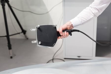 Operator doing quality control or inspection with handheld professional 3D laser scanner