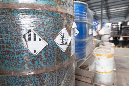 Waste barrel with hazard warning symbol in the warehouse
の写真素材