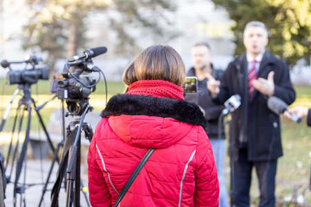 Shooting media event or news conference with a video camera. Public relations - PR concept.の写真素材