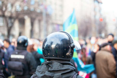 Riot police on duty during crowd protest or demonstrationの写真素材