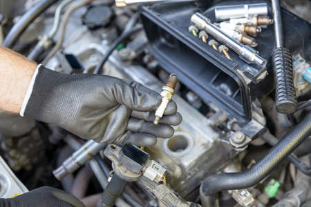 Car spark plug replacement. Repairing of vehicle.の写真素材