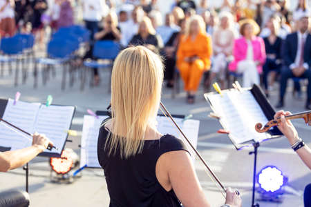 Classical music concert outdoors, blurred audience in the backgroundの写真素材