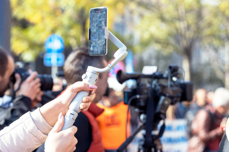 Mobile journalist filming media event with a smartphoneの写真素材