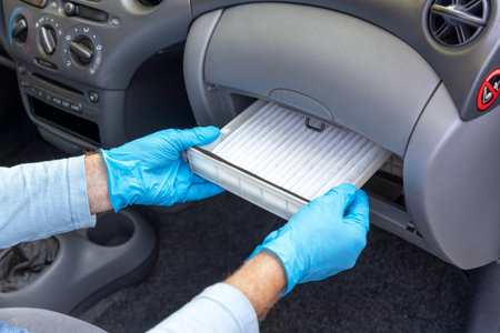 Replacing cabin pollen air filter for vehicleの写真素材