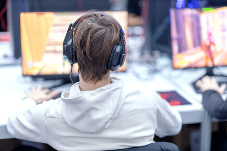 Young gamer playing online computer video game. Video game addiction concept.