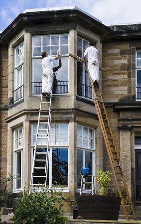 Painters working on the outside of a buildingの写真素材
