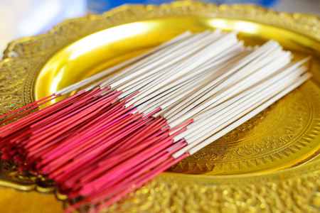 Red Incense sticks on tray with pedestalの写真素材