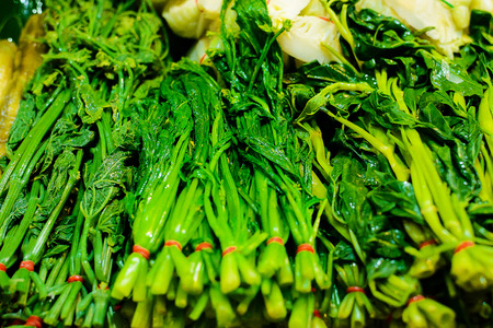 A pile of fresh raw green Chinese kale ready for sale - cleanly washedの写真素材