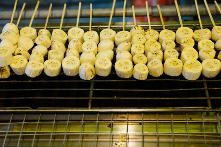 Grilling banana in stainless steel stick ready for dessert.の写真素材