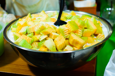 some pieces of cantaloupe for sweet coconut milk in stainless bowl.の写真素材