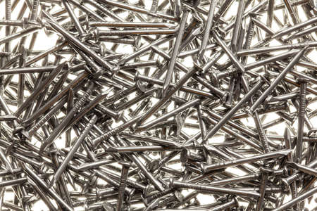 Many steel nails on white backgroundの写真素材
