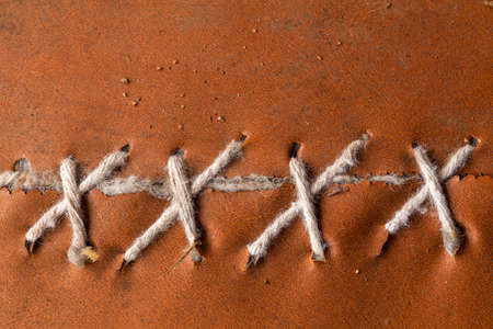 Handmade needlework with strings on leatherの写真素材