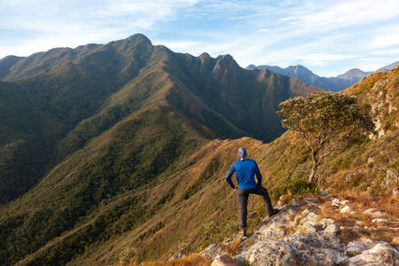 Unrecognized people enjoying the mountain landscape view from a mountain