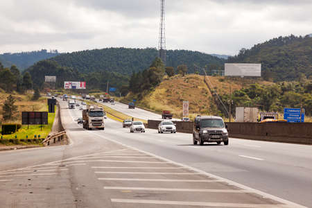 SAO PAULO, BRAZIL - JUNE 20, 2016 - Vehicles on BR-374 highway with headlights on during the daylight obeying the new Brazilian transit lawsのeditorial素材