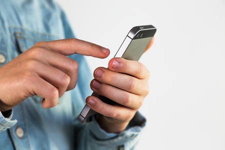 finger on smartphone display