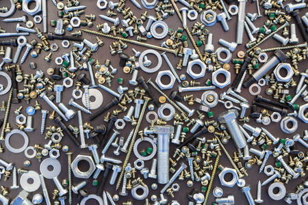 screws and nuts on a metal plateの写真素材