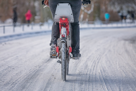 cyclist on snow covered streetの写真素材