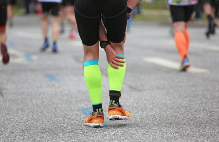 Marathon runner with a calf cramp