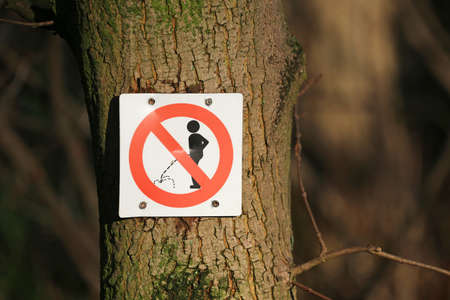 peeing prohibited sign on a tree