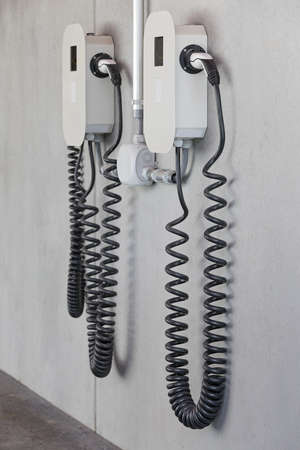 electric charger with cables on concrete wallの写真素材