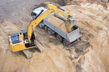loading sand on a truck with a diggerのeditorial素材