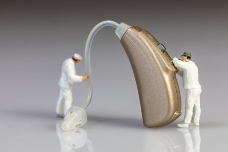 audiologists doing hearing aid maintenanceの写真素材