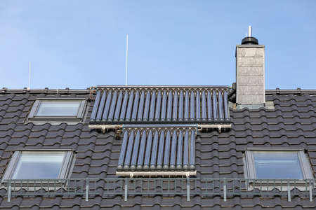 solar thermal panels on rooftop of residential buildingの写真素材