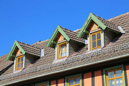 wooden dormer on rooftop of old residential building