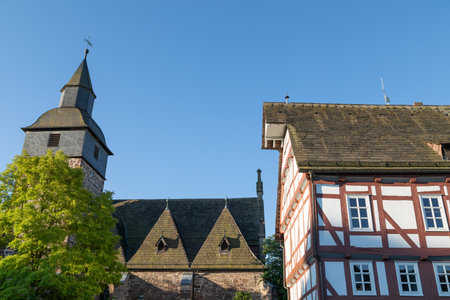 half-timbered house and church in small town Trendelburgのeditorial素材