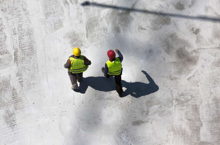 aerial view of two workers walking on construction siteの写真素材