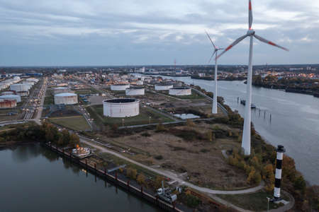 wind turbines and oil tanks in the port of Hamburgの写真素材