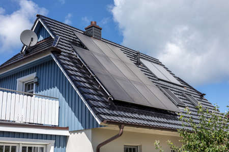 solar systems on the pitched roof of a family home
