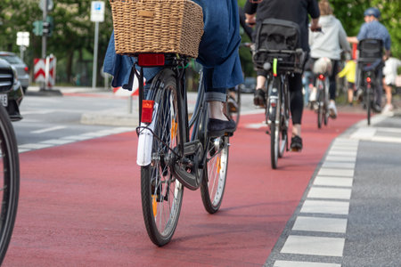 cyclists cross road on red bike crossingの写真素材